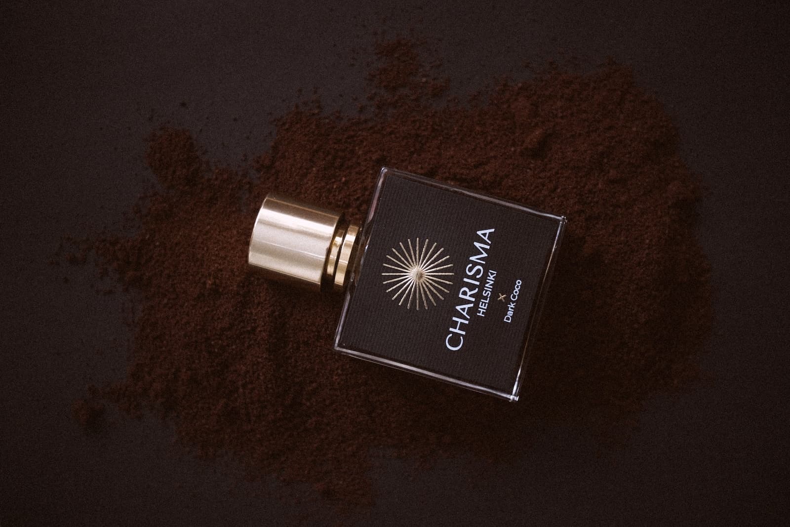 Dark Coco by Charisma Helsinki, resting on scattered cocoa